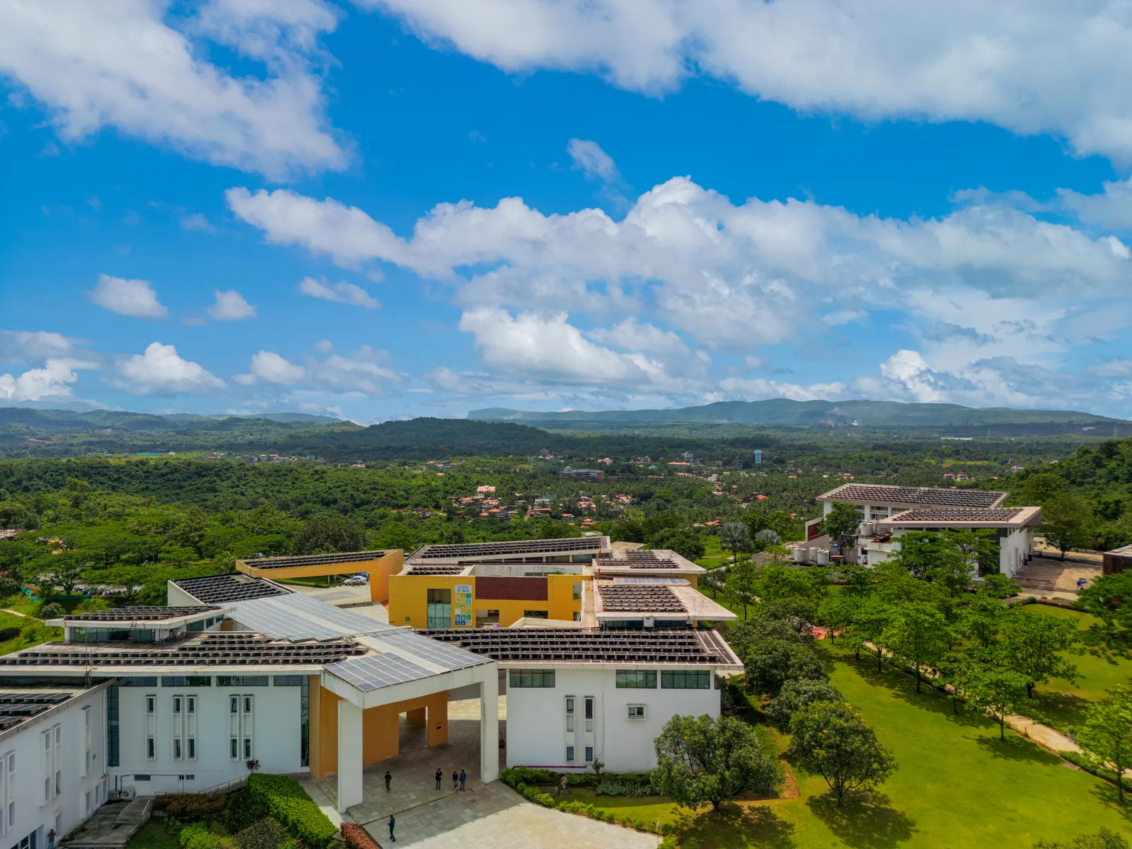 Aerial view of the solar-panelled Goa Institute of Management campus against the Western Ghats